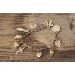 A 9ct gold charm bracelet, oval links, with various charms in 9, 10 & 14cts, 17 cm, 12g