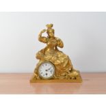 A late 19th century Ormolu mantle clock, depicting a gazing women, enamel dial with Roman