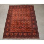 A modern Persian carpet, red wool with geometric design, 176cm x 231cm