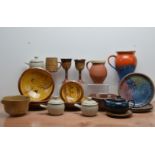 A collection of studio pottery, including terracotta slipware bowls by Tony & Sue Davies, with