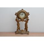 A 20th century mantle clock, in the Louis XIV style, cast metal, with two figures holding the clock,