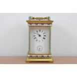 An early 20th century brass and cloisonne carriage clock, enamel dial with roman numerals (worn) and