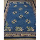 A large modern Chinese style carpet, blue with symmetrical design 285cm x 366cm