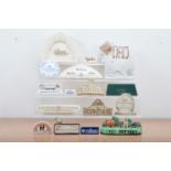 A collection of ceramic advertising plaques, including Coalport, Lenox China, Spode, Nao, Lladro,