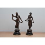 Two cast metal figurines, of Modestie and Gaiete, both on wooden stands, both 30cm high (2)