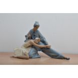 A Lladro ceramic figural group, of a ballerina and clown, printed and impressed marks to the base