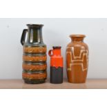 Three West German pottery vases, two with handles, of differing designs and styles, all marked to