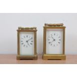 Two 20th century brass carriage clocks, of different sizes, both with enamel dials with roman