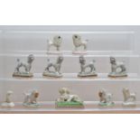 A collection of 19th century and later ceramic Staffordshire poodles, comprising two pairs on