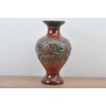 A large West German Pottery baluster vase, green and red glaze, raised design of a hunter on