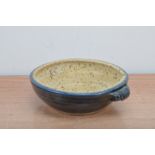 Mike Braisher, a stoneware studio pottery twin handled bowl, blue outer glaze with spotted interior,