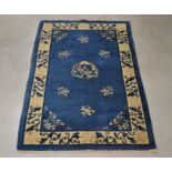 A Chinese rug, blue with scrolling design, worn label to the underside, 178cm x 123cm