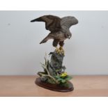 A large Border Fine Arts figurine of a Bird of Prey, marked RT Roberts on the base, 49cm high, on an