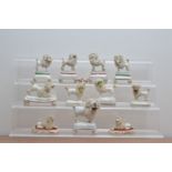 A collection of 19th century ceramic Staffordshire poodles, comprising two pairs with birds in their