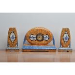 A 20th century continental ceramic clock garniture, yellow and blue glaze, with blue and white