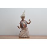 A large Lladro ceramic figurine of a kneeling Thai lady, impressed and printed marks to the