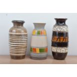 Three West German pottery vases, of differing designs and sizes, one with a large crack and repair