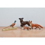 Three ceramic Beswick animal figurines, comprising a large and small fox, a Pheasant on a