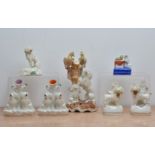 A collection of 19th century ceramic Staffordshire poodle spill vases/ink wells, comprising a tall