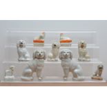 A collection of 19th century ceramic Staffordshire poodles, comprising a pair, 15.5cm high, a