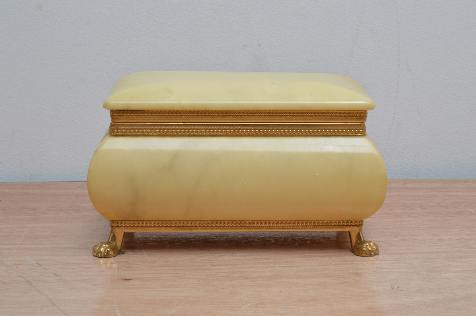 A modern decorative alabaster and brass mounted jewellery box, Italian, raised on four lion paw