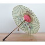 A white metal handled Indian parasol, with a bamboo shaft, makers mark to the leaf, with a canvas