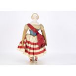 An A W Kister mid 19th century bisque shoulder head patriotic doll, with blue painted eyes, red