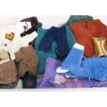 A large selection of hand knitted clothes for dolls and teddy bears, including thirty cardigans,