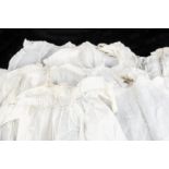 A quantity of girl’s toddler clothes, twelve cotton or muslin dresses, a similar number of under-
