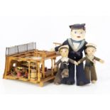 Three cloth sailor dolls and a cross-section model of a gun deck on a 18th century battleship, the