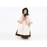 A late 19th century German pegged wooden doll, with blue painted eyes, painted black hair with