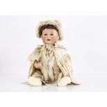A German 1914 Jutta character baby, with blue lashed sleeping flirty eyes, brown mohair wig, bent-