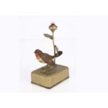A German cast-metal robin lamp 1930s, standing on gold painted metal battery box with rose bud light