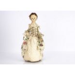 An English second half of the 18th century turned and painted wooden doll, with dark inset enamel