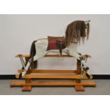 A large 20th century child reocking horse, pine wooden frame, the paint peeling off in areas,