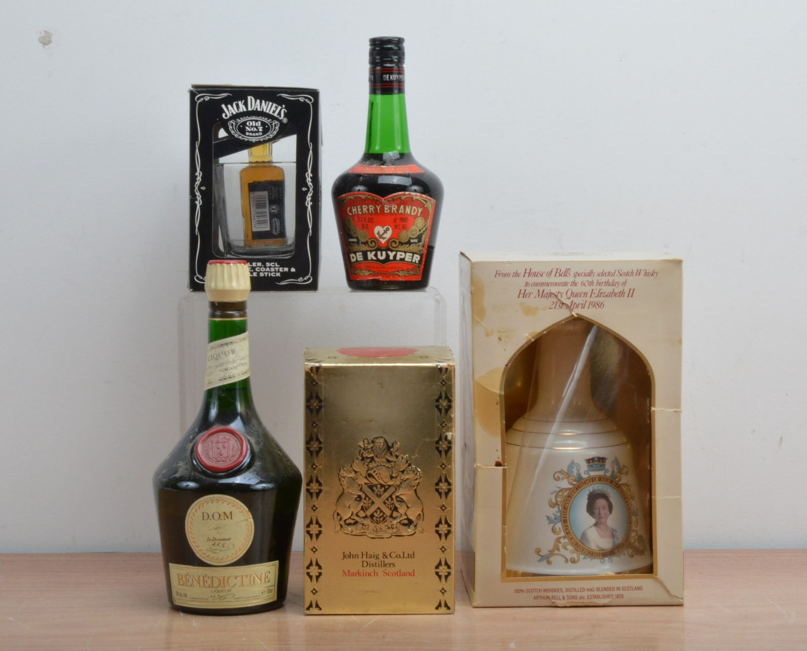 A collection of spirits, comprising a Bells Whisky Royal commemorative decanter in a box, a bottle