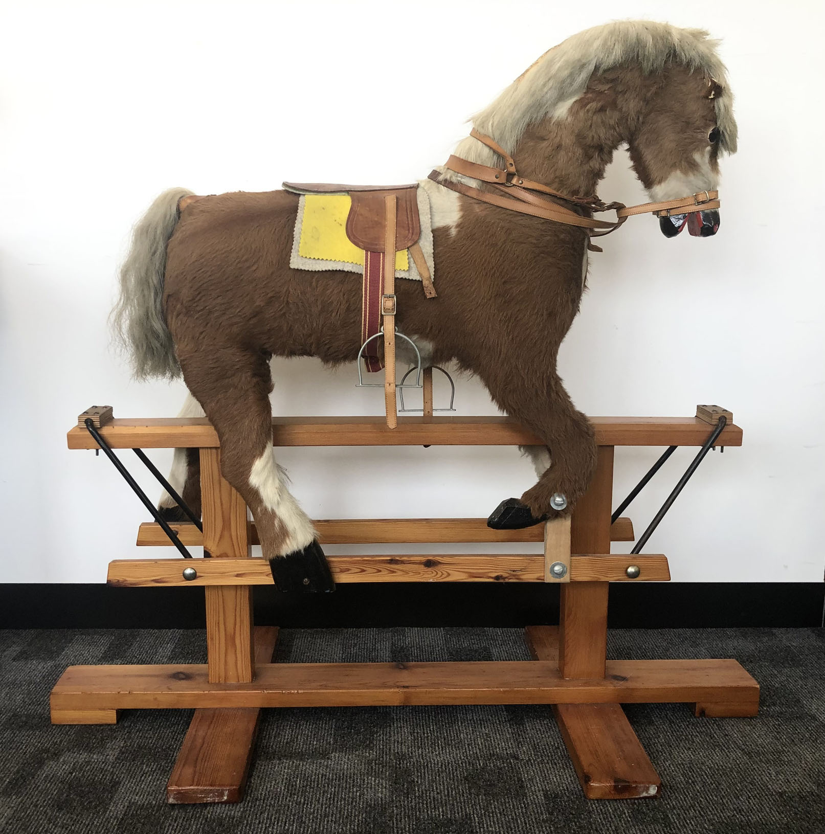 A late 20th century rocking horse, probably wooden body covered in fur with carved wooden nose and