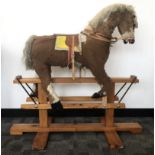 A late 20th century rocking horse, probably wooden body covered in fur with carved wooden nose and