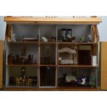 A modern dolls house, with furniture and two dolls, some pieces of furniture with damage 84cm H x