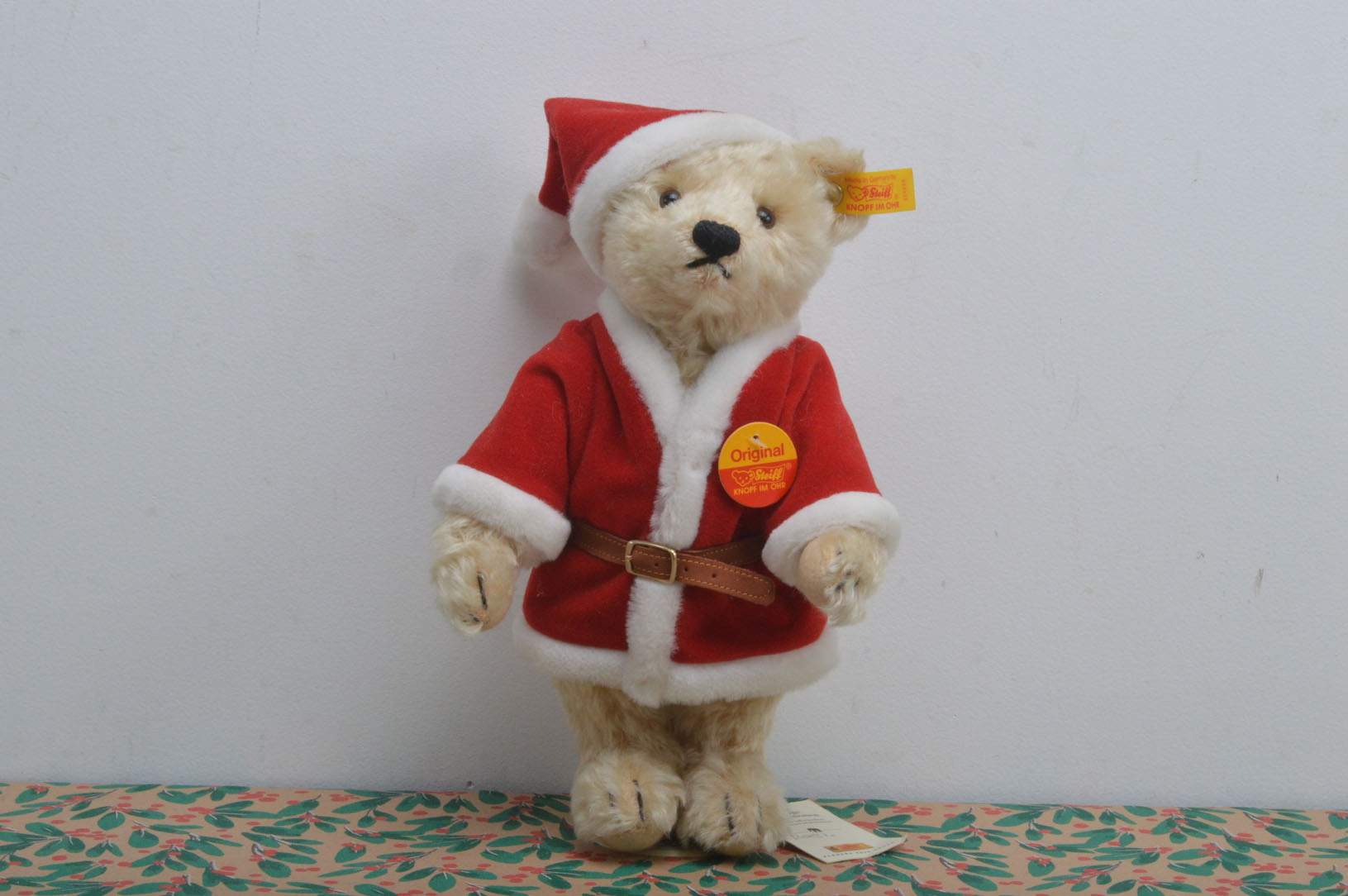 A modern Steiff yellow tag Christmas Teddy bear, blond mohair, known as Noel, on Russ stand, 27cm