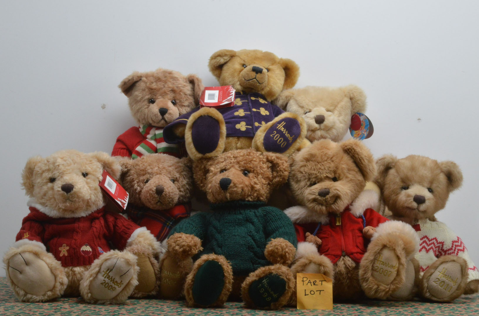 A collection of Harrods Christmas teddy bears, some with original retail labels, of differing