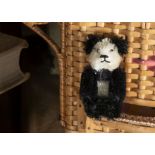 A post-war Schuco miniature Panda Teddy Bear, with black and white mohair, black pin eyes, black