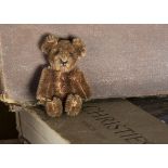 A post-war Schuco miniature Teddy Bear, with brown mohair, black pin eyes, black stitched nose and