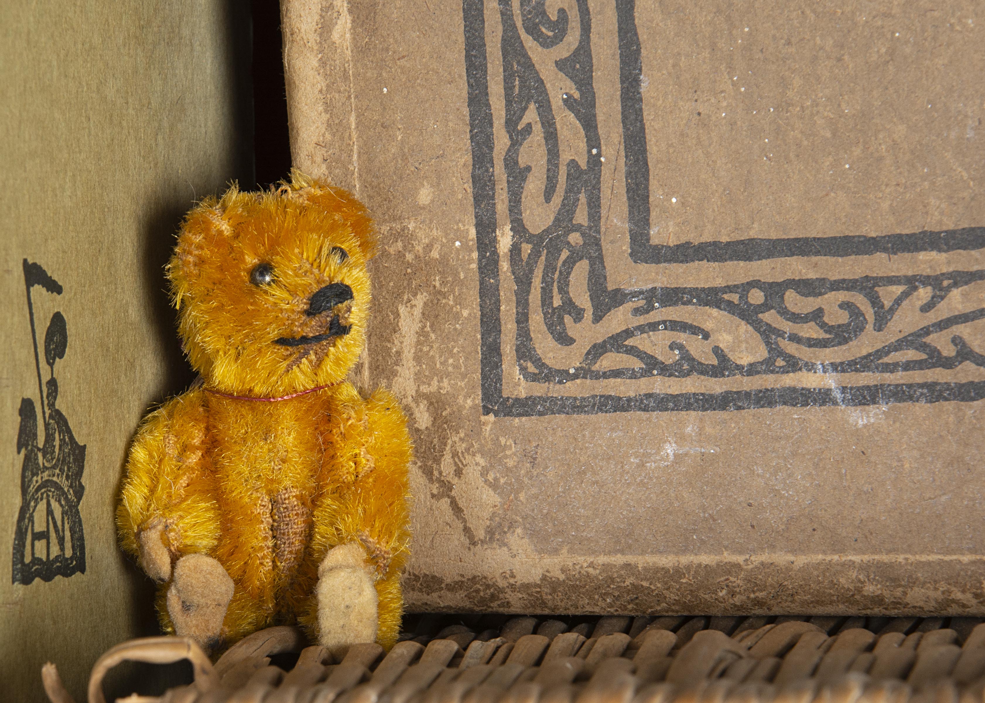 Westonbirt - a miniature Schuco Teddy Bear 1920s, with golden mohair, black pin eyes, black stitched