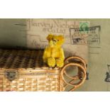 A post-war Schuco miniature Teddy Bear, with bright golden mohair, black pin eyes, black stitched