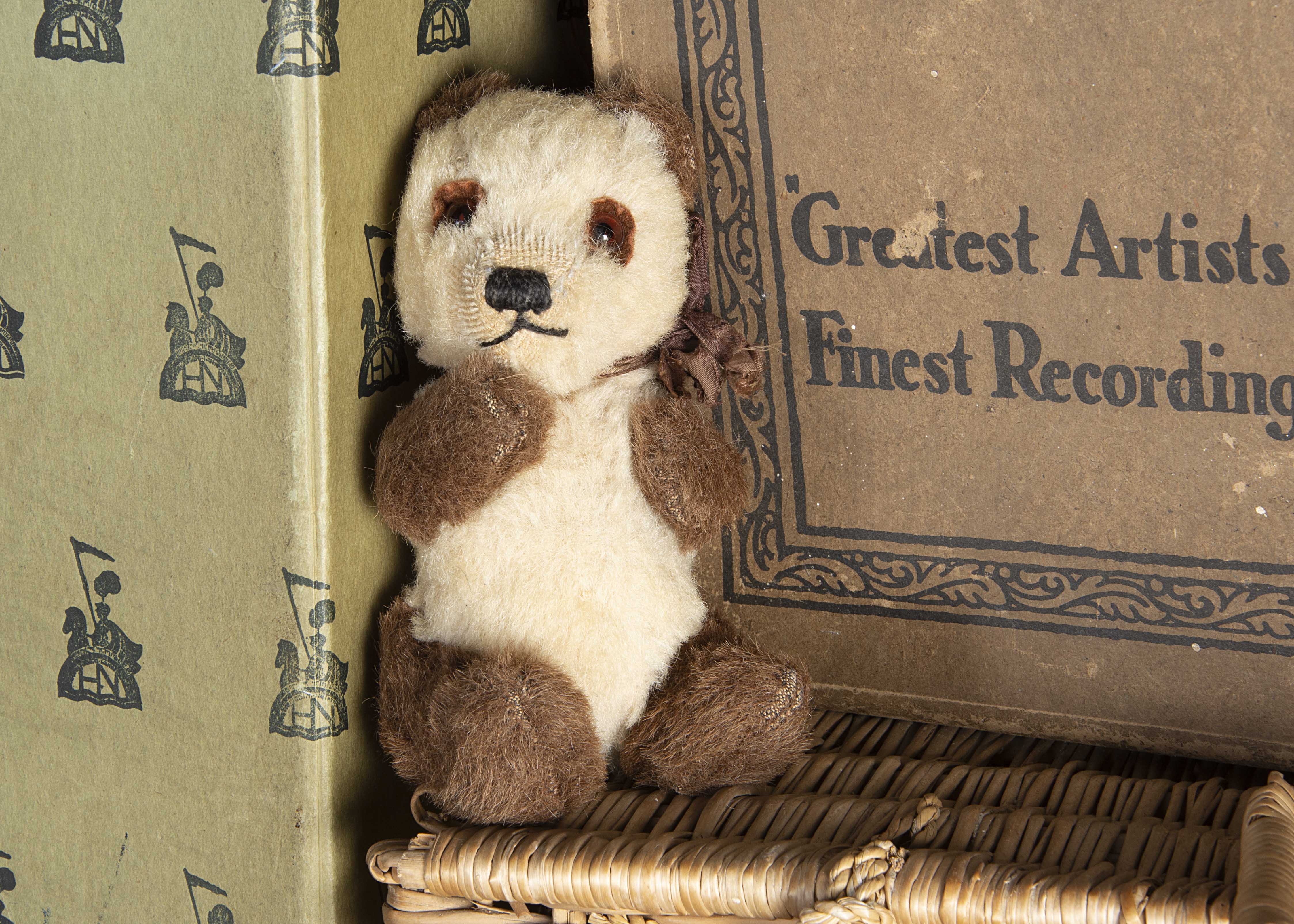 A small 1930s Chad Valley Panda cub Teddy Bear, with white wool plush and brown alpaca, orange and