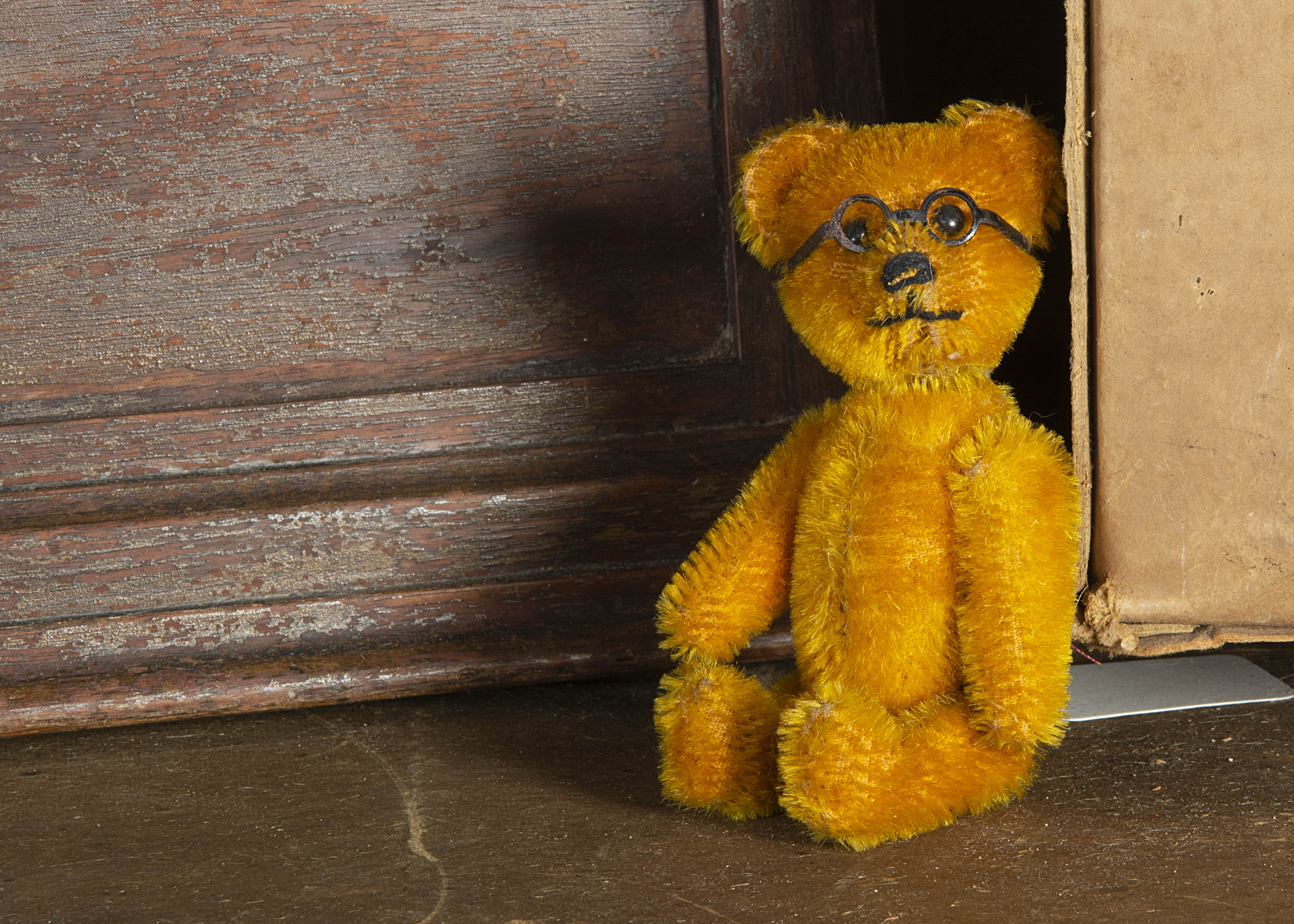 A rare small Schuco yes/no Teddy Bear with glasses 1930s, with golden mohair, black boot button