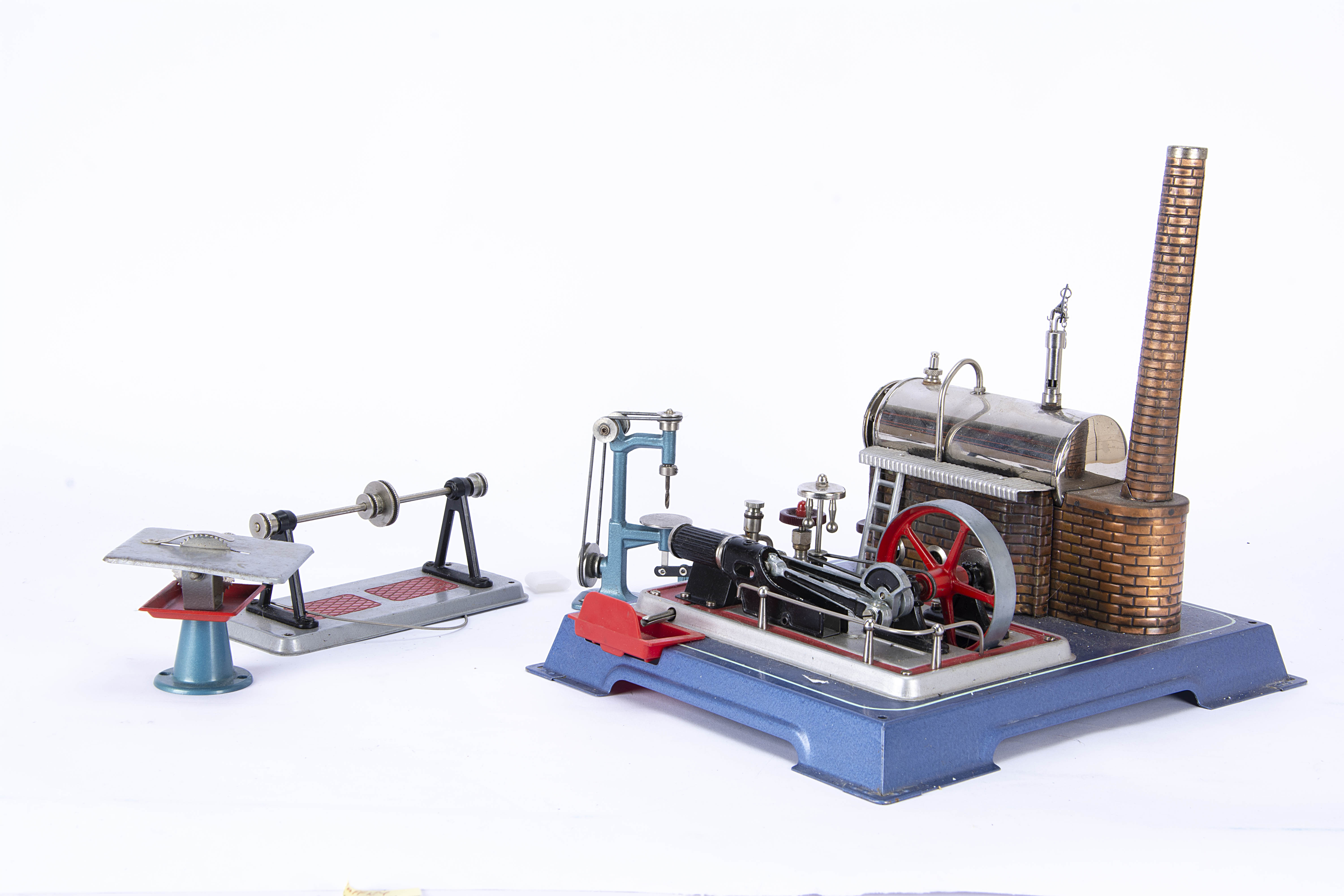 A Wilesco live steam tablet-fired Stationary Engine and Accessories, on blue base with red trim,
