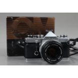 An Olympus OM-1n SLR Camera, shutter working, meter responsive, self timer working, body G, with