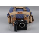 A Nikon FM Camera Body, black, serial no 2553900, shutter working, meter responsive, body F-G,